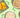 Dried mango slices, almonds, coconut flakes, and white beans in ceramic bowls on a green background